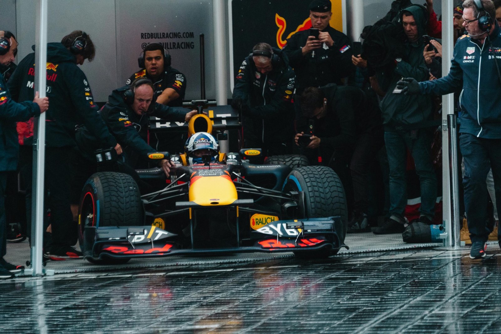 Exciting Formula One car during a dynamic pit stop, showcasing teamwork and precision.